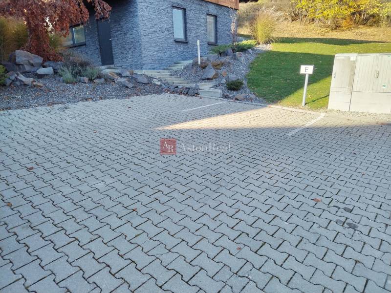 Parking lot at the cottage in the Martin district of Stráne with paved tiles and a landscaped garden.