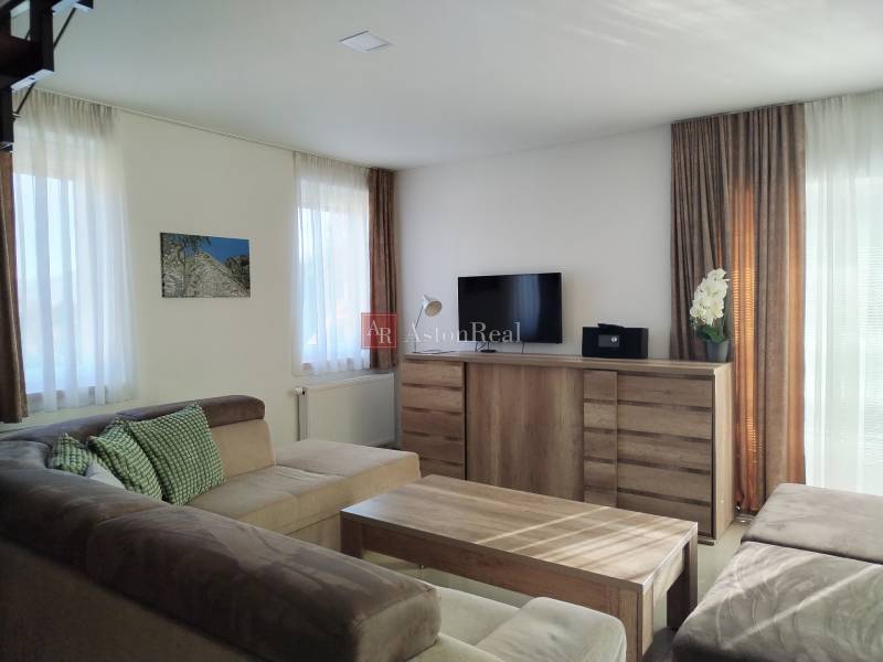 A bright room in a cabin with a comfortable sofa and a wooden decor floor.