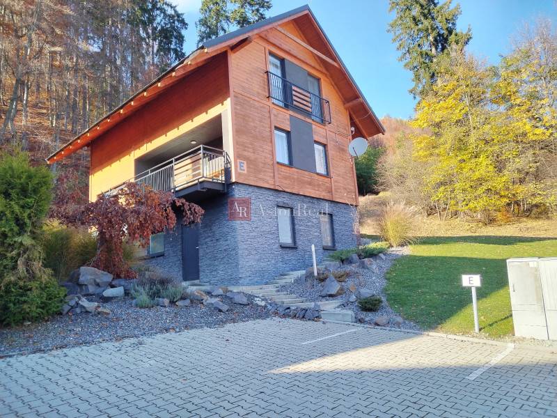 A cottage in Martin on Stráne with stone cladding, wooden decor, and a parking space.