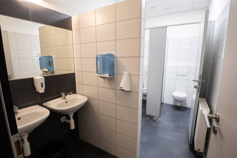 Offices: Sinks and toilet in areas with tiling and dispensers.