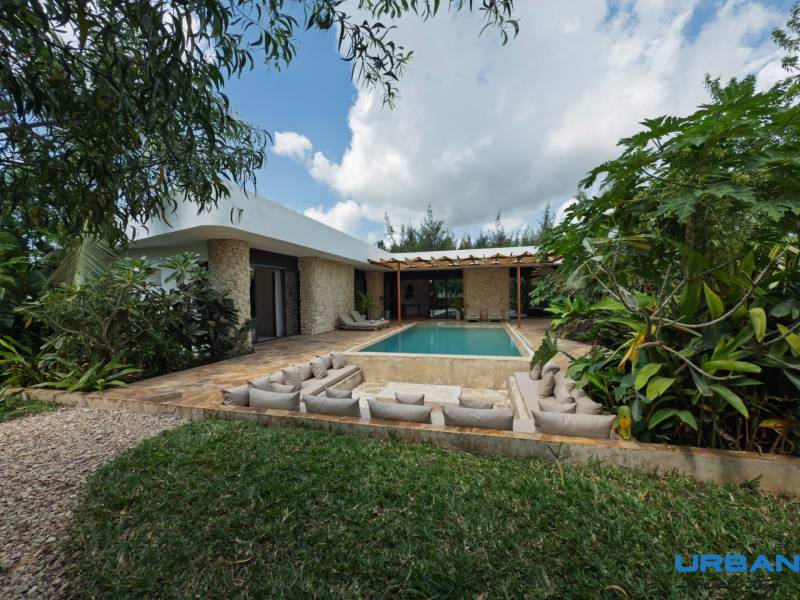 A house with a swimming pool surrounded by greenery on Paje Street in the Unguja South Region.
