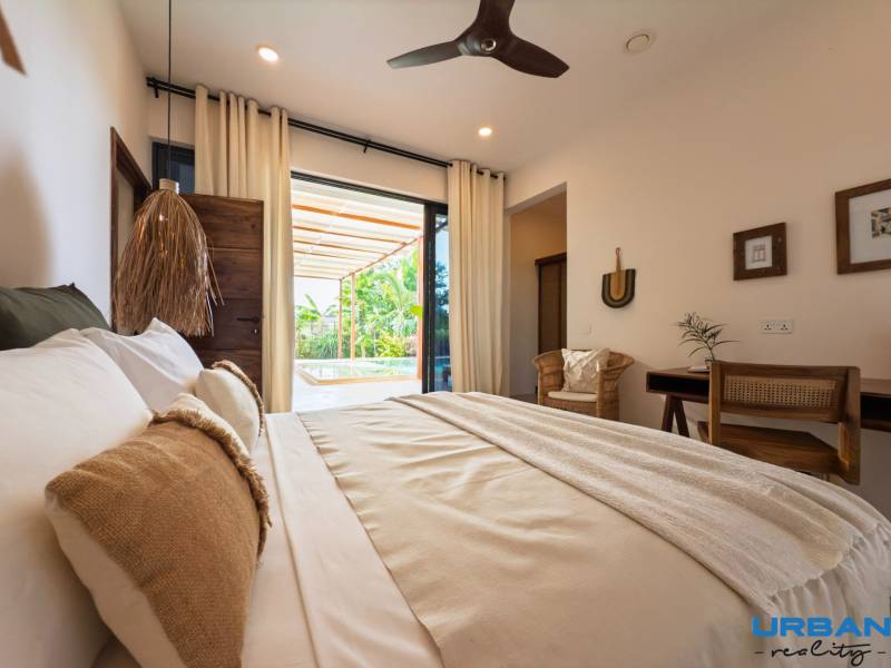Bedroom interior with a spacious bed and a view of the terrace, House construction.