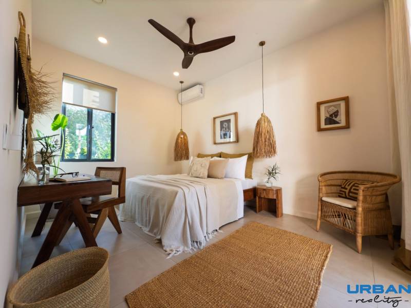 A bright bedroom with pendant lamps and wicker furniture in a family house.