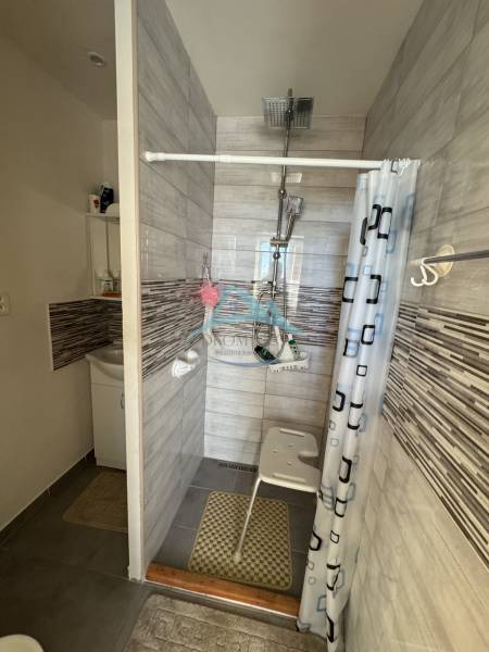 A bathroom in a 3-room apartment with a modern shower and a screen.