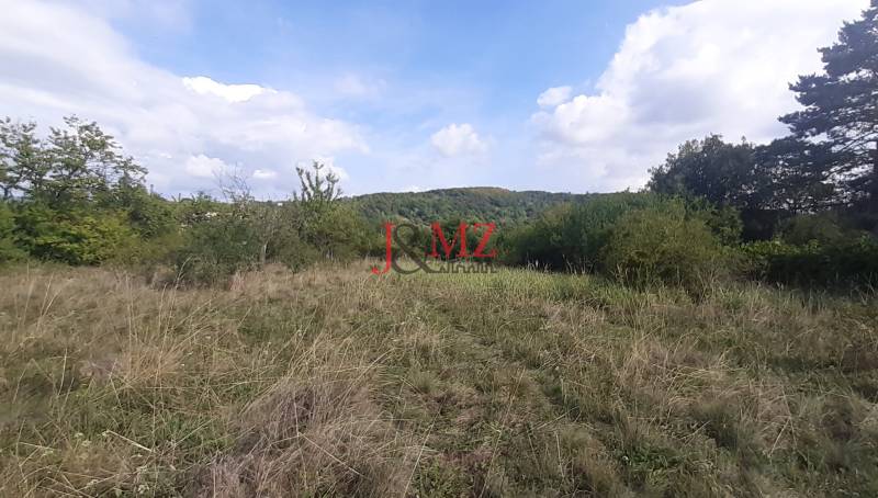 The landscape on the recreational grounds in Jabloňovce, part of Horné Jabloňovce, with a view of the wooded hills.