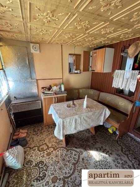 Interior of a cottage with an antique patterned table and wooden details in the Gardens.