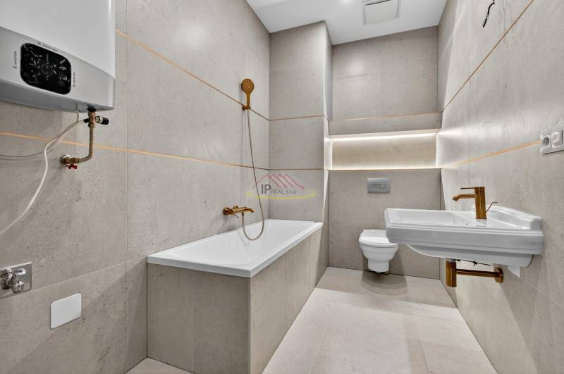 Bathroom in a 4-room apartment with a bathtub, sink, and toilet in neutral shades.