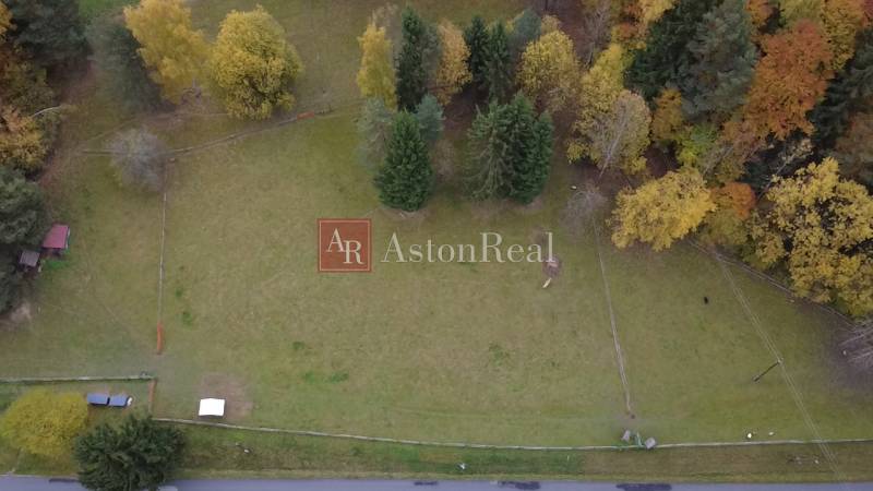 Aerial view of green recreational plots surrounded by trees on Čertov street, Lazy pod Makytou.