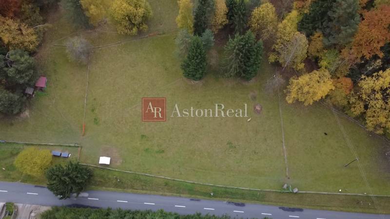 Recreational plots in Lazy pod Makytou, Čertov surrounded by trees and an access asphalt road.