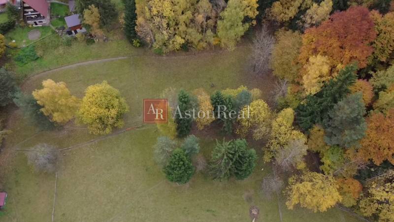 Autumn view of recreational plots in Lazy pod Makytou, Čertov, surrounded by trees of various colors.