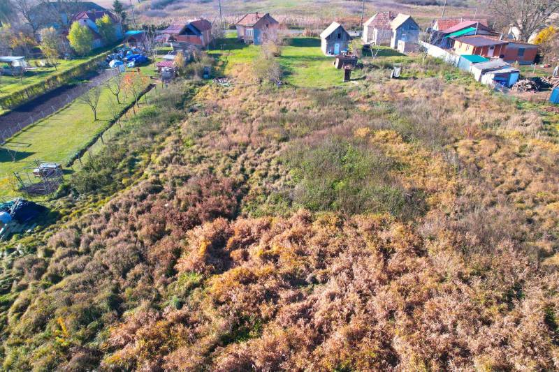 Aerial view of residential plots in Radnovce with rural houses and greenery.
