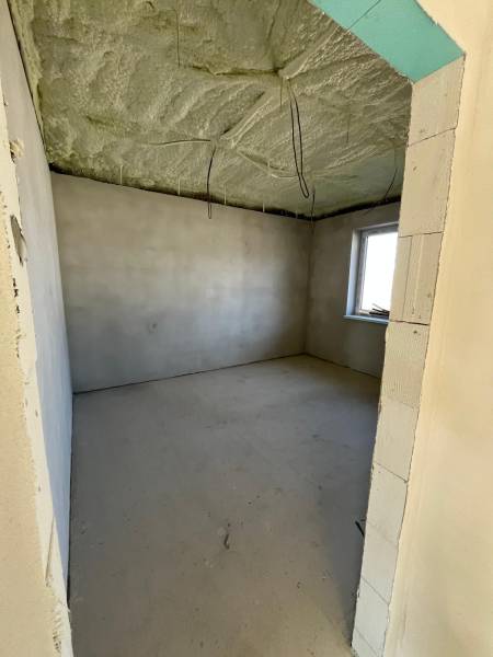 Room under construction with a window, thermally insulated ceiling, in a family house Vyšná Šebastová.