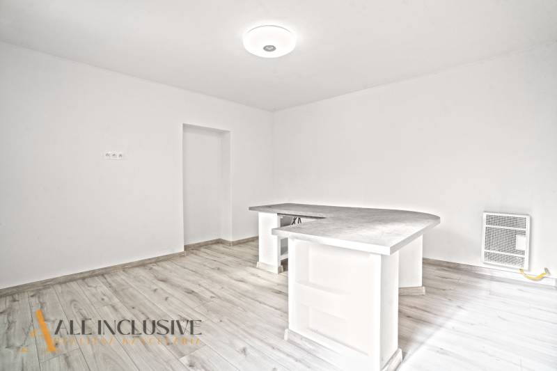 A kitchen with a wooden decor floor in a family house, minimalist bar counter.