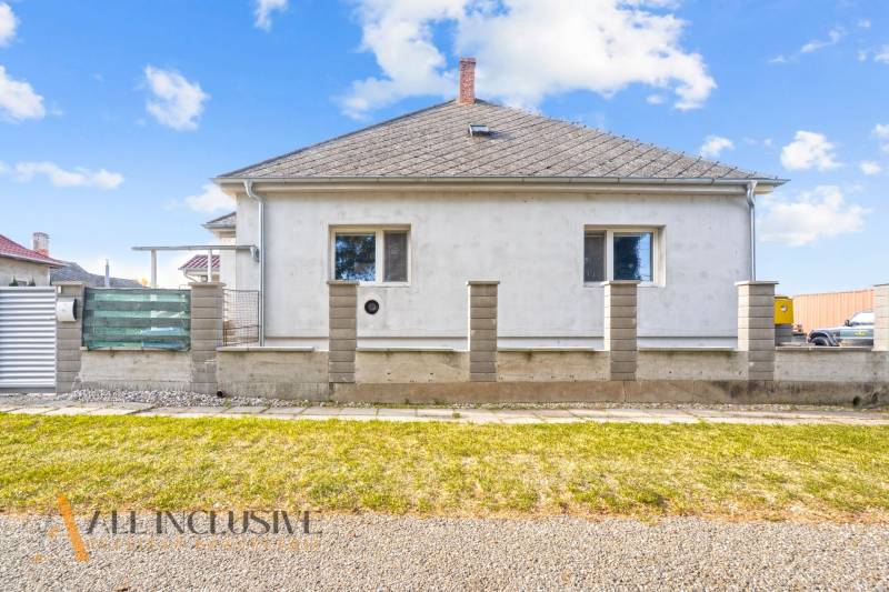 A family house in Veľké Kosihy with a simple facade and a landscaped outdoor area.