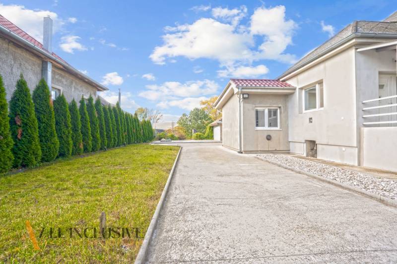 A family house in Veľké Kosihy with a driveway and a well-maintained lawn.