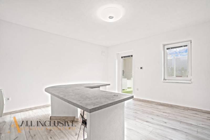 Interior of a family house with a counter and floor with wooden decor.