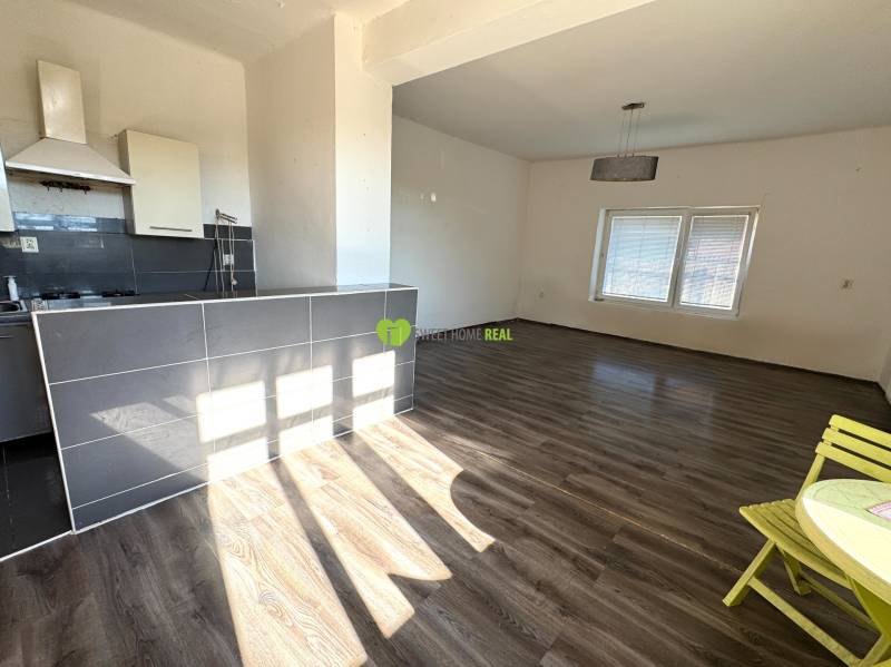 Interior of a family house with a kitchen, counter, and floor with wood decor.
