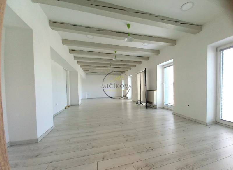 Bright offices with wood-patterned flooring and large windows.