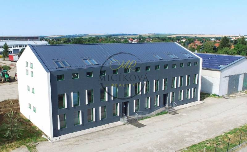 The building on Levická Street in Vráble with offices, modern architecture, and green surroundings.