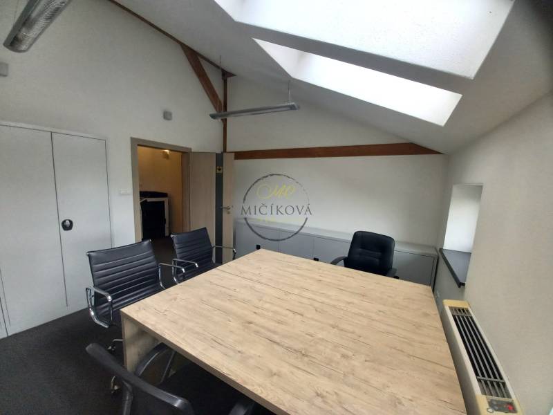Office with a dining table and wooden decor flooring, seating for four people.