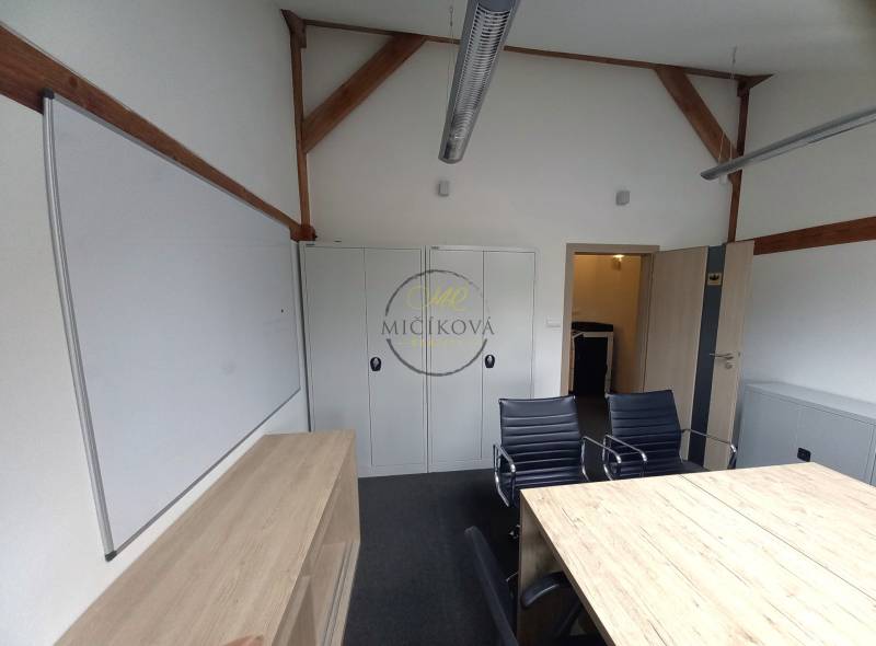 Offices with a desk, black chairs, cabinets, and a whiteboard.