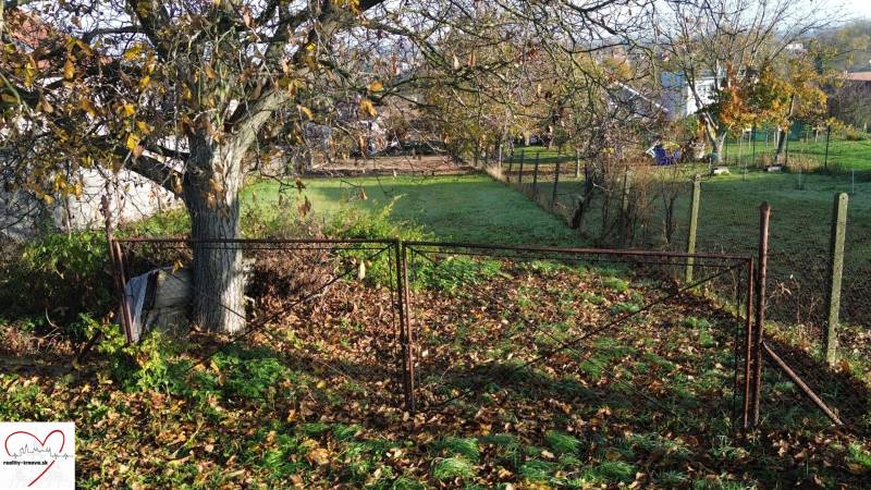 A plot for residential purposes in Dolná Krupá on M.H. Chvoteková Street with autumn leaves and trees.