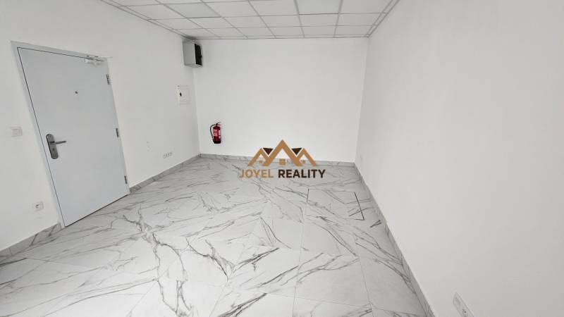 White walls, marble tiles, commercial spaces, fire extinguisher.