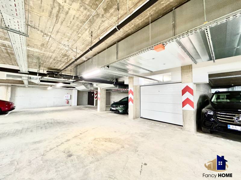 Garages with parking spaces, concrete ceiling, and lighting on Karpatská Street in Poprad.