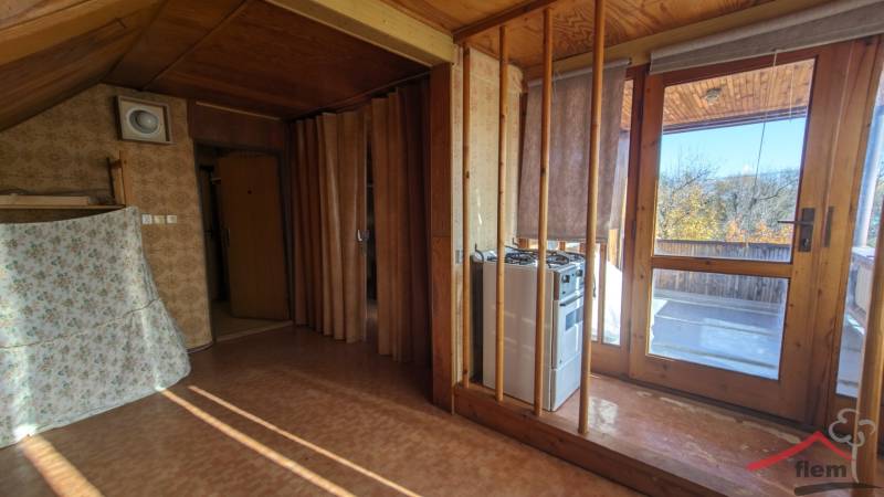 The interior of a family house with doors to the terrace and walls with a wooden decor.