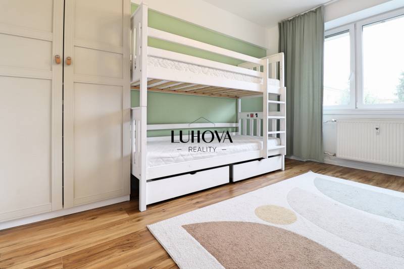 A children's room in a three-room apartment with a bunk bed and a floor with a wooden decor.
