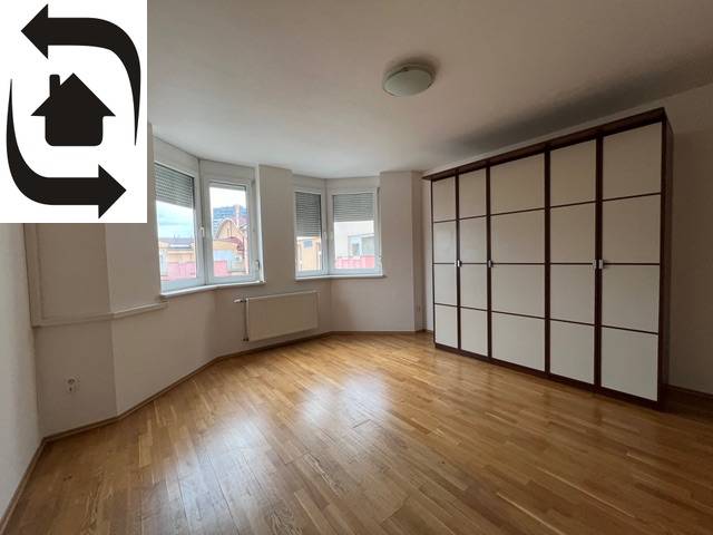A spacious room with wooden flooring and a built-in wardrobe in a 3-room apartment.