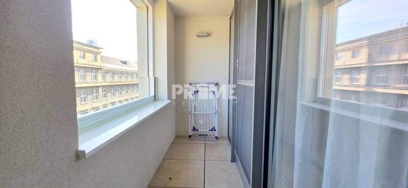 Balcony of a 2-room apartment with white tiles and a view of the street in Bratislava - Staré Mesto, Bezručova.