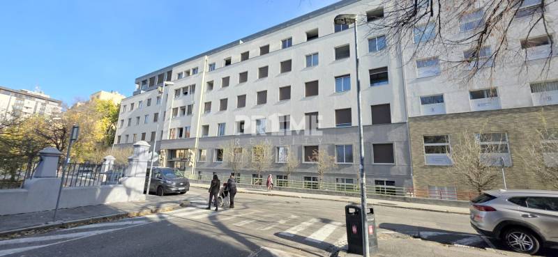 Building on Bezručova Street in Bratislava - Old Town, facade with windows and pedestrians.