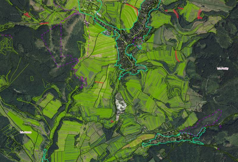 Aerial view of agricultural and forest lands around the village of Poniky.