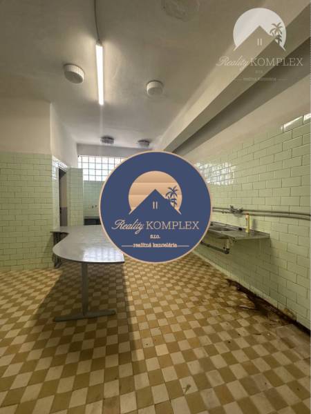 Interior of commercial premises with tiling and work surfaces, suitable for business.