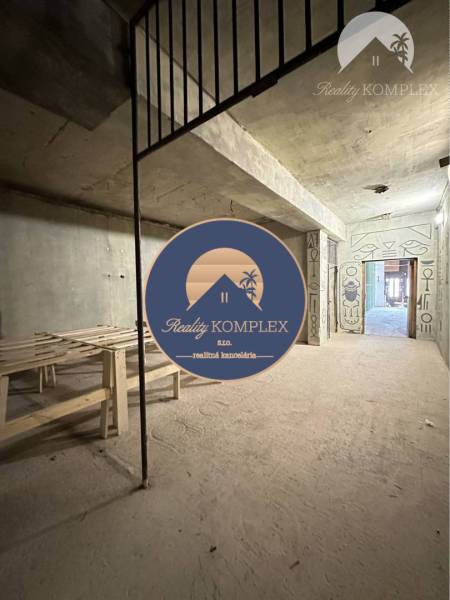 Construction business premises with a concrete ceiling and Egyptian paintings on the walls.