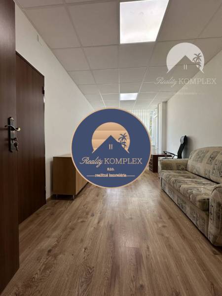 Offices with wood-patterned flooring and a sofa.