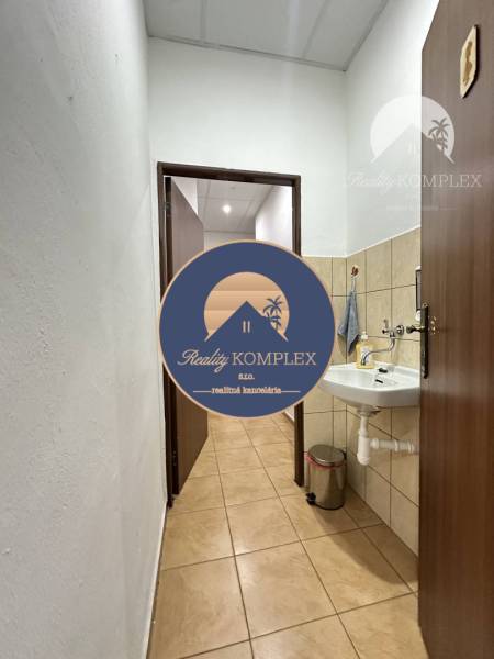 Offices with a sink and tiled floor, a cozy space for work.