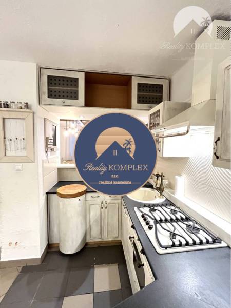 A kitchen with a kitchenette and a gas stove in a 3-room apartment.