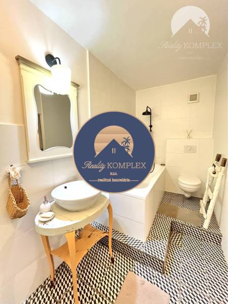 A stylish bathroom in a 3-room apartment with a unique floor and a shower tray.