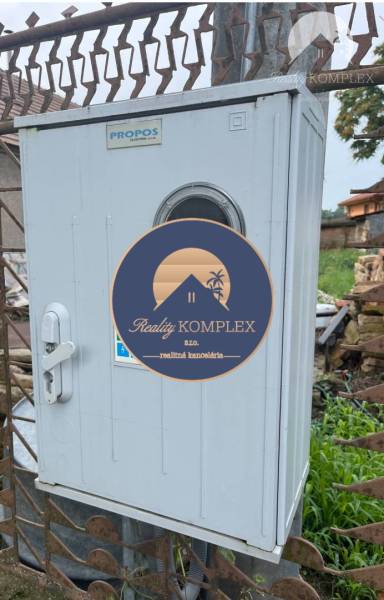 Electrical cabinet near residential plots in Iža, suitable for infrastructure.