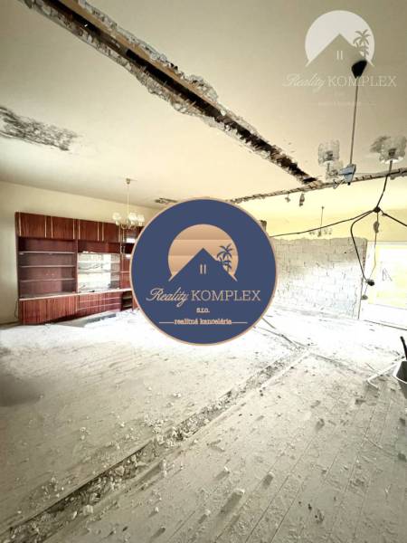 The interior of a family house with an exposed ceiling and construction materials on the floor.