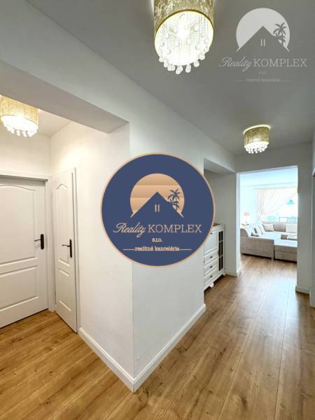 Interior of a family house with a wooden decor floor and chandeliers.