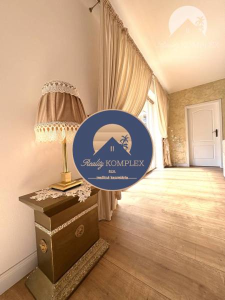 Interior of a family house with a lamp, curtains, and a wooden decor floor.