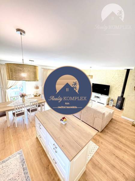 Interior of a family house with a wooden decor floor, dining table, and sofa.