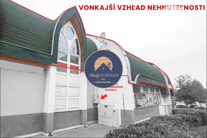 Exterior of commercial premises in Komárno with an interesting roof and modern windows.