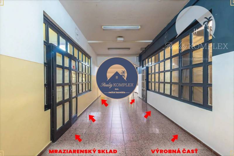 A corridor with doors leading to the freezing storage and production area.