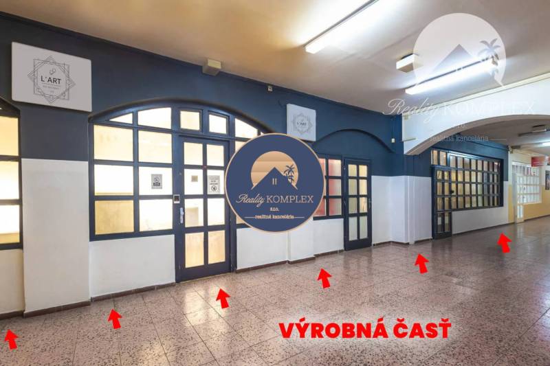 Interior of commercial spaces with glass doors and illuminated ceiling lighting.