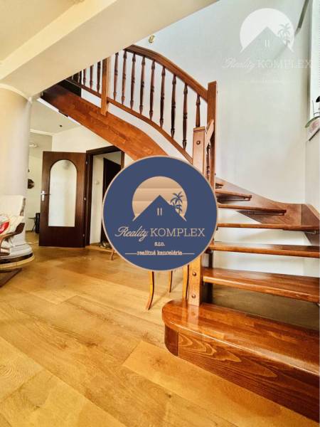 Wooden staircase with a wood-patterned floor in a family house.