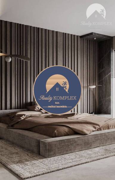 Stylish bedroom with an upholstered bed, wooden paneling in a 2-room apartment.